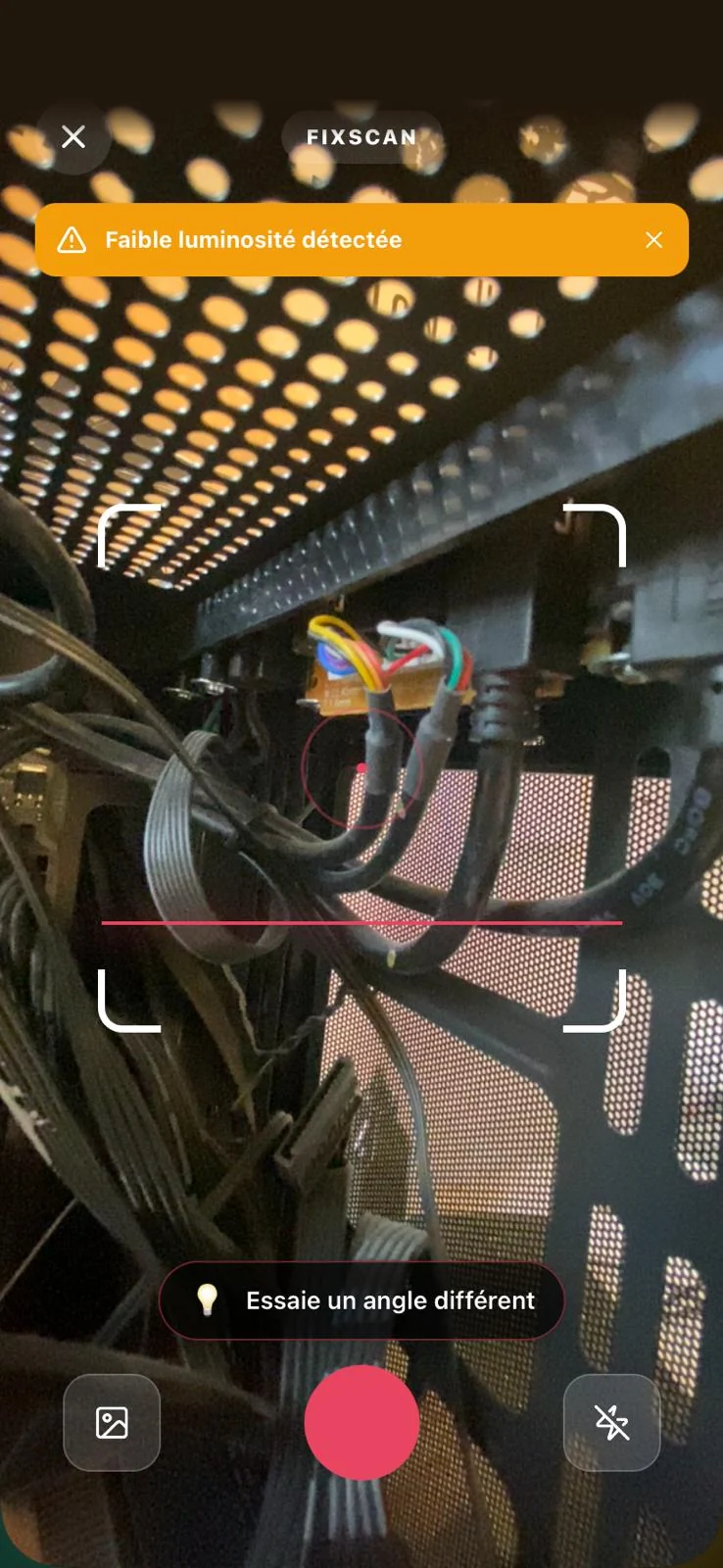Le scan de FixScan&nbsp;: la caméra cadre un PC, avec l’alerte « Faible luminosité détectée ».
